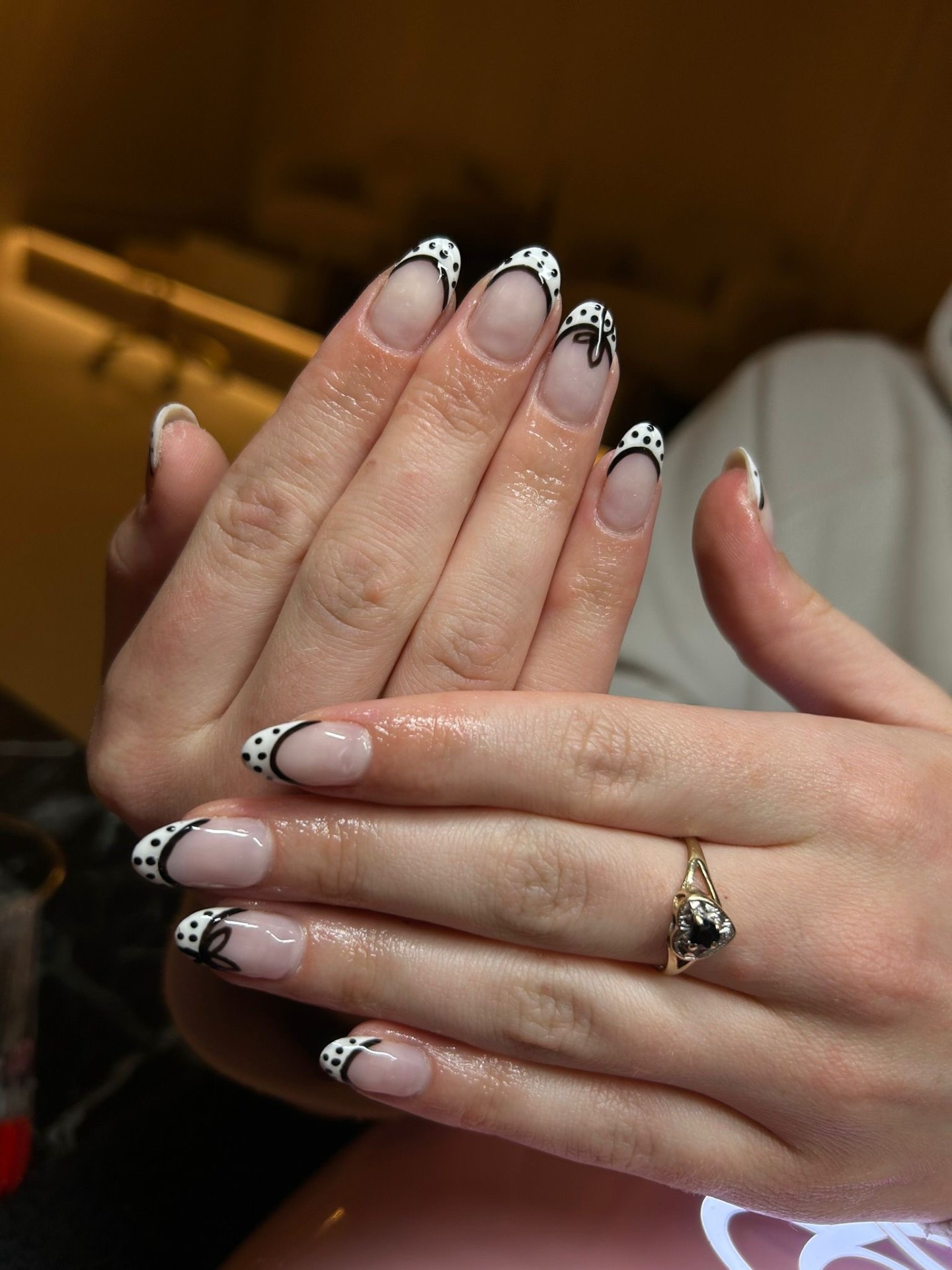 Almond French tips with black dot and bow detailing