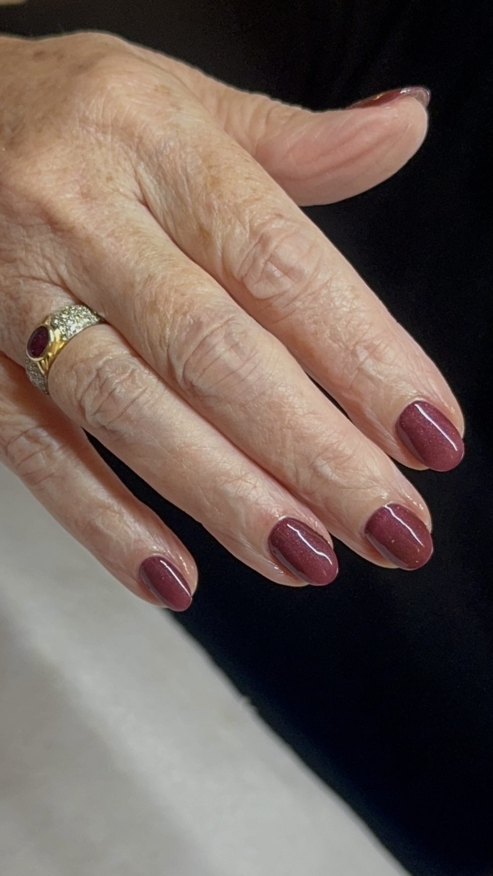 Glossy burgundy shimmer manicure